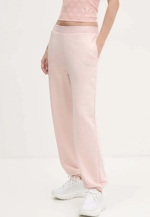 Pantalons de survêtement roses en tissu doux, dotés de poches latérales, d'une coupe décontractée et de subtils embellissements pour plus de détail.