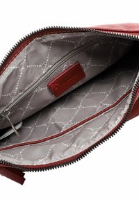 Red leather bag interior with a smooth gray lining, featuring a zippered pocket and visible logo pattern. Zipper closure along the top.