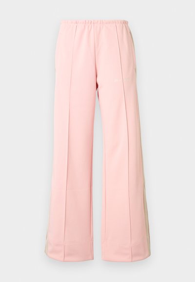 Ανοιχτό ροζ φόρμα παντελόνια με ελαστική μέση, διαθέτουν δύο πλαϊνές τσέπες και αντίθετες μπεζ πλαϊνές λωρίδες. Απαλή, λεία υφή υφάσματος.