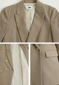 Ljusbrun skräddarsydd kavaj med slag, två knappar och en bröstficka. Insidan är fodrad med krämfärgad tyg.