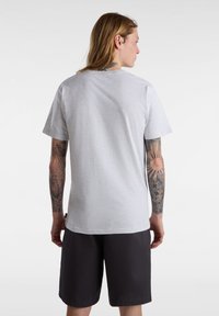 Short-sleeve gray cotton t-shirt with a crew neck, shown from the back. Features a relaxed fit and plain design, paired with dark shorts.