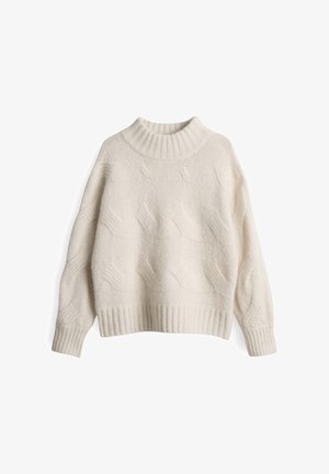 Pull en maille crème avec un col montant à côtes, des manches longues et des motifs en vagues texturés. Présente un ourlet et des poignets à côtes.