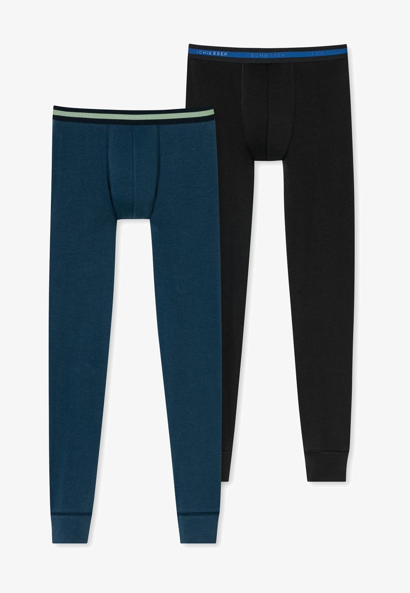 Twee paar herenmutsen: één in donkerblauw met een lichtgroene tailleband, de andere in zwart met een blauwe tailleband. Katoenmengsel, zachte textuur.