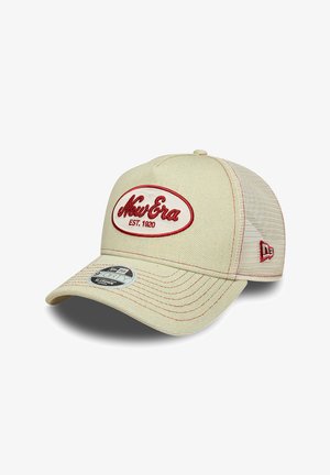 Beige New Era mesh-back cap with red embroidered logo "New Era EST. 1920" on front and red stitching details.