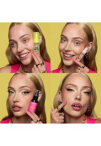 Jeune femme aux cheveux blonds montre des produits de maquillage NYX et applique du maquillage, mettant en valeur les lèvres et le visage sur un fond jaune.