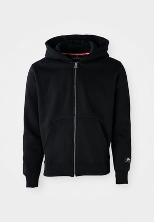 Black zip-up hoodie made of cotton blend fabric. Features a front pocket, drawstring hood, and ribbed cuffs. Simple design with minimal accents.