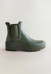 Groene rubberen enkellaarzen met elastische zijkanten, gestructureerde zolen en een dikke, verhoogde platform voor grip en stabiliteit.