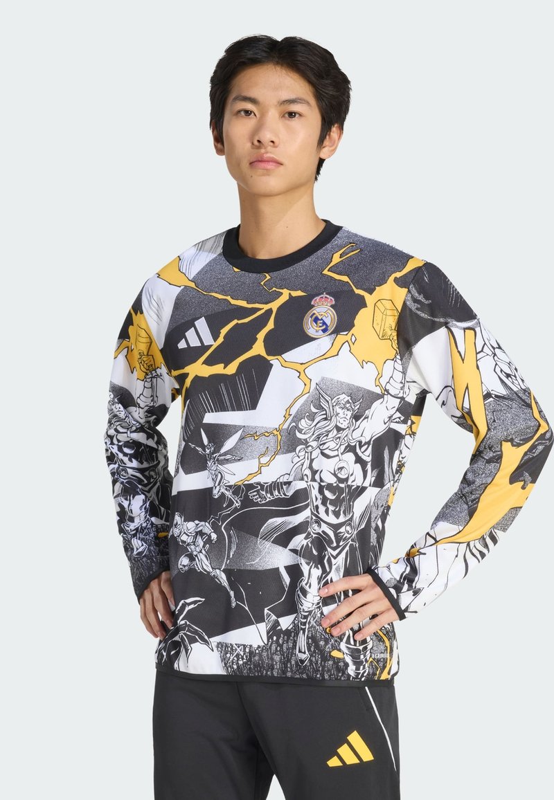 Felpa a maniche lunghe con grafica che presenta un design in nero, bianco e giallo con supereroi in stile fumetto e accenti di lampi. Colletto e polsini neri.