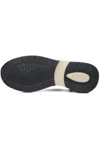 Zwarte rubberen schoenzool met diepe profielen en groeven, met een glad beige middenstuk en een merklogo dat erop is gedrukt.