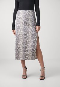 Snake print mid-length skirt featuring a slit on the left side, made from a smooth fabric in neutral tones with dark accents.