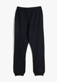 Schwarze, elastische Sweatpants mit schmal zulaufenden Beinen, aus weichem, strukturiertem Stoff. Keine sichtbaren Muster oder Hardwaredetails.