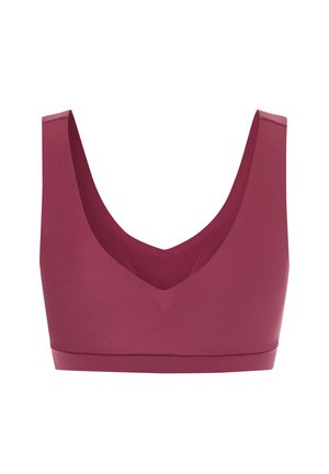 Mauve sports bra with a wide, smooth band and a deep V-neck. Crafted from stretchy material, it features minimal seams for comfort.
