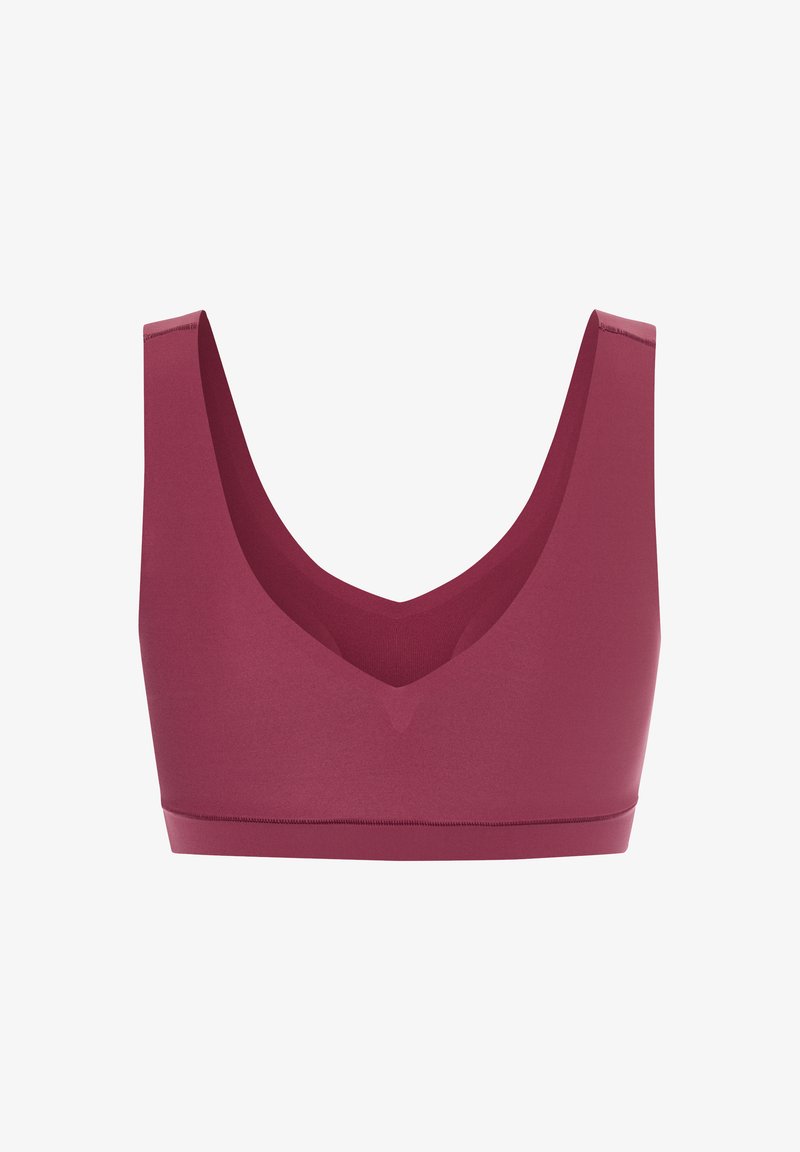 Mauve sportbh med en bred, slät band och djup V-ringning. Tillverkad av elastiskt material, har den minimala sömmar för komfort.
