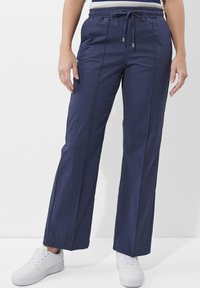 Marineblaue, weit geschnittene Hose mit elastischem Taillenbund und Kordelzug, ausgestattet mit seitlichen Taschen und einem glatten, leichten Stoff.