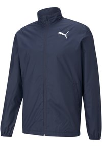 Veste coupe-vent Puma en bleu marine, avec un col haut, une fermeture éclair intégrale, des manches longues et un logo blanc sur la poitrine gauche.
