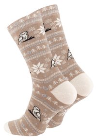 Beige socks with winter-themed patterns, featuring white snowflakes and black birds. Reinforced cream-colored toe and heel sections.