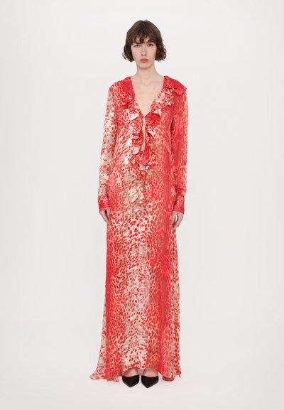 Maxi dress in sheer red and beige with a spotted pattern. Features ruffled neckline and long sleeves. Floor-length with slim silhouette.