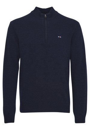 Námornícky modrý pulóver so zipsom do polovice, s rebrovanými manžetami a lemom. Obsahuje malé trojfarebné logo na hrudi. Mäkká pletená textúra.