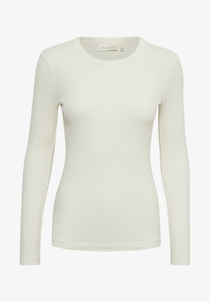 Top a maniche lunghe a costine di colore avorio, con scollatura rotonda e design aderente. Realizzato in un materiale morbido e liscio con una sottile texture.