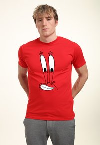 Red cotton t-shirt featuring a cartoon crab face graphic with large eyes and a wide grin, round neckline, and short sleeves.
