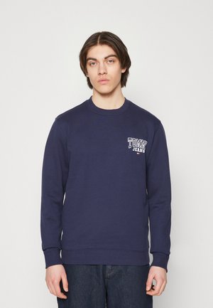 Felpa color blu navy realizzata in tessuto misto cotone, con scollo a girocollo e polsini a costine, e un piccolo logo bianco sul petto.