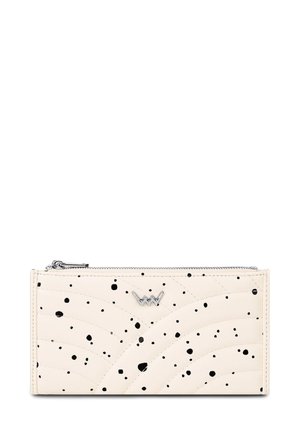 Cream wallet with black irregular spots, silver zipper on top, and a small silver crown-shaped logo in the center front.