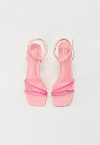 Sandali con tacco alto rosa con una finitura matte liscia, caratterizzati da sottili cinghie e un anello alla caviglia. Design a punta quadrata con una struttura minimalista.