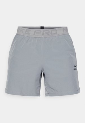 Hallid hallid sportlikud lühikesed püksid elastse vöökoha ja "NIKE PRO" hallides tähtedes, väikese musta Nike logo jaotusega jalal.