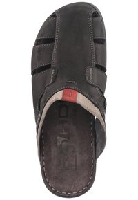Brown leather sandal with cross straps, a textured insole, and red accent. Features stitching detail and an open-back design for easy wear.