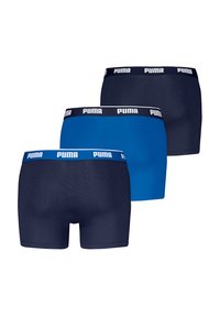Trois paires de caleçons en présentant une palette de couleurs bleue, bleu foncé et marine. Chaque paire dispose d'une ceinture élastique de marque.