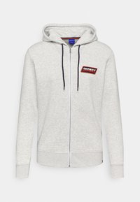 Felpa zip con cappuccio grigio chiaro, tessuto testurizzato, patch rosso e nero "ORIGINALS" e lacci a contrasto. Maniche lunghe con polsini a costine.