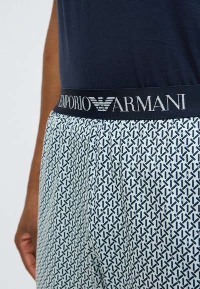 Modré bavlnené tielko s bielym a námorníckym vzorom v spodnej časti, s námorníckym pásom s logom "Emporio Armani".