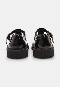 Zwarte lakleren schoenen met een chunky, gestructureerde zool, achterband en een brede gesp. Glad afwerking met een ronde neus.