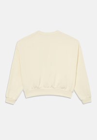 Világos sárga pulóver laza szabással, kerek nyakkivágással és bordázott mandzsettákkal. Puha, texturált anyag, derékrészen összegyűrt szegéllyel.