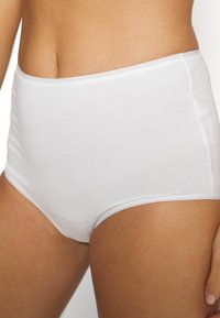 White cotton high-waisted brief with a smooth texture, featuring a wide waistband and straight-cut edges, providing full coverage.