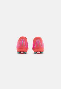 Soccer cleats in vibrant pink with gradient accents, textured upper, and turquoise studs. Features branded details on the heel.