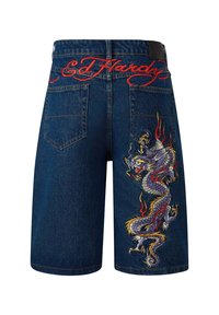 Denim shorts with blue fabric, featuring red embroidered "Ed Hardy" text and a colorful dragon design with flames on the side.