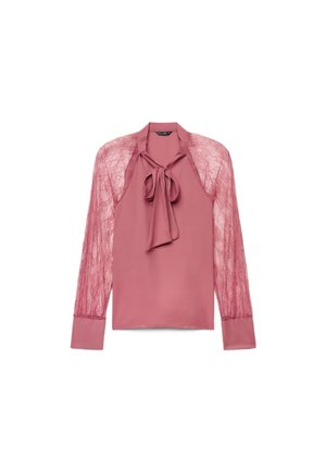 Blouse rose avec manches longues en dentelle transparente et un nœud noué à l'encolure, avec des poignets et un col en tissu uni.