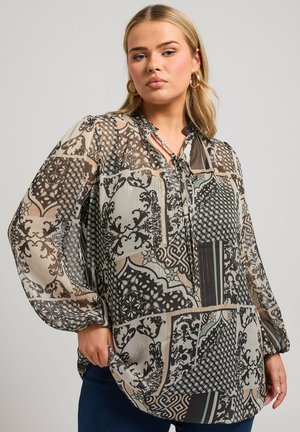 Blouse transparente présentant un mélange de motifs noir, beige et sarcelle, avec un col noué et de longues manches bouffantes. Tissu texturé et léger.