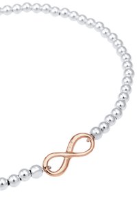 Silverfärgad pärlhalsband med ett roséguld oändlighetslås. Pärlorna är runda och enhetliga i storlek, vilket ger en slät och polerad yta.