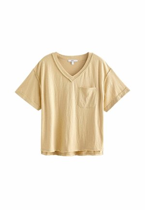 Jasnobeżowy bawełniany t-shirt z krótkim rękawem, dekoltem w serek, kieszenią na piersi i lekko luźnym krojem.
