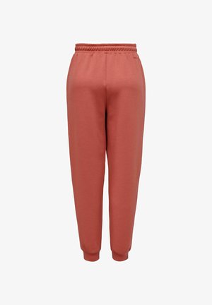 Joggers confortáveis e ajustados em terracota clara, feitos de uma mistura de algodão suave, com cintura elástica e punhos, apresentando detalhes de design minimalistas.