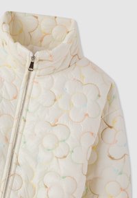 Giacca puffer crema con colletto alto, zip frontale e motivi floreali multicolore a patchwork su tutta la superficie.