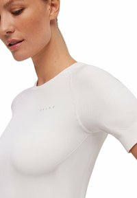 White athletic shirt with a round neckline and short sleeves. Features ribbed texture on shoulder areas and subtle branding on the chest.