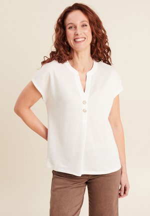 White short-sleeve blouse with a V-neck, featuring two buttons at the front, made of a lightweight fabric. Casual fit and minimal design.