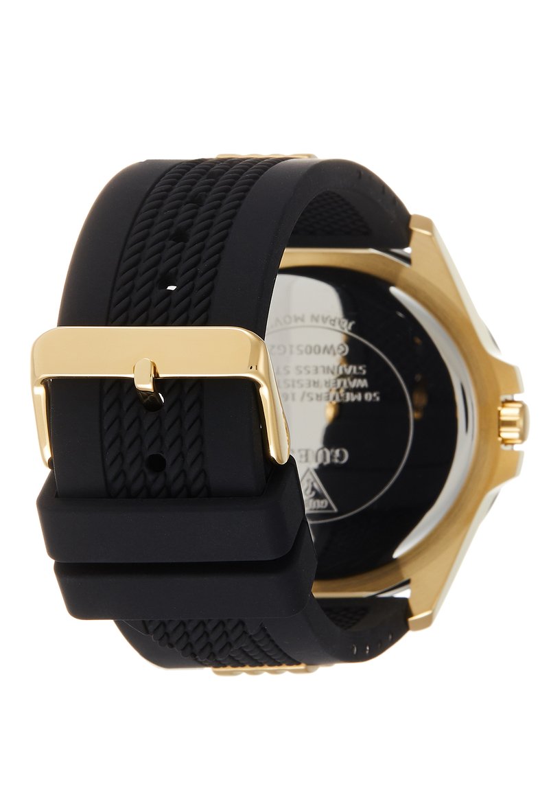 Correa de reloj de silicona negra texturizada con hebilla dorada y fondo de caja de reloj dorado que muestra la marca grabada y las especificaciones.