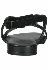 Black flat sandals with a textured leather upper, featuring crisscross straps and an adjustable buckled ankle strap. Flat sole.