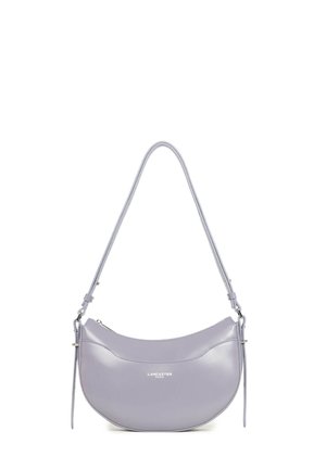 Lilac crescent-shaped leather shoulder bag with thin adjustable strap and small silver Lancaster Paris logo on front.