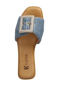 Blue woven slide sandal with a wide strap featuring a rhinestone buckle and a tan faux leather insole, showcasing a flat sole design.