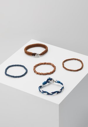 Sæt af fem armbånd: brunt vævet, træperler i lyse og mørke nuancer, blåt perlearmbånd, og et blå-hvidt snoet design med metal accenter.
